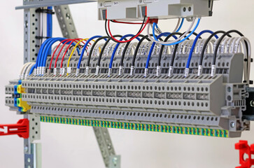 Electrical terminals with connected insulated copper wires with metal lugs. Marking with a thermal printer. 