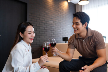 Romantic date at home. happy  man and his girlfriend holding glasses of wine while talking and laughing