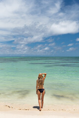 Tourist walking into the ocean in colombia, enjoying summer vacation