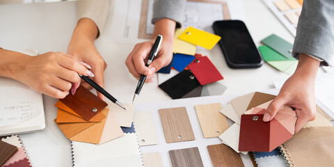 Close up on hands of  interior designer working on new house design project in office. choosing...