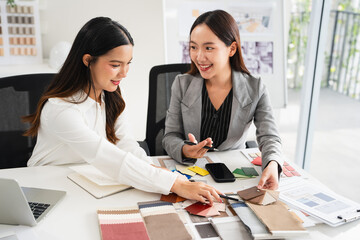 Interior design, two working colleagues designers, or decorator and client choosing finishing...