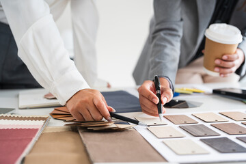 Close up on hands of Woman architect designer teamwork select material compare samples finishing....