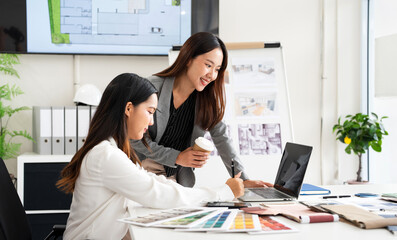 Two Designers With Laptop Meeting In Modern Office