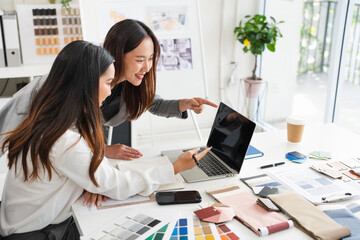 Two Designers With Laptop Meeting In Modern Office
