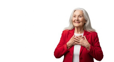 Elderly woman with long gray hair wearing a red blazer, smiling warmly with hands on her heart