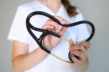 A healthcare professional holds a stethoscope, showcasing its importance in patient assessments....
