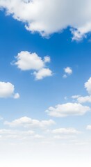 Obraz premium Clear blue sky with fluffy white clouds scattered across, creating a serene atmosphere for relaxation