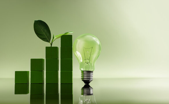 Green blocks forming  growing bar graph next to light bulb with leaf. Green business, Clean energy investment and eco-friendly innovation