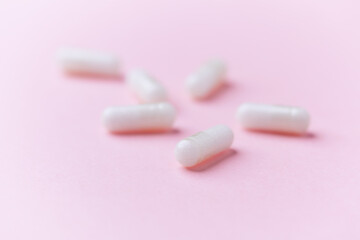 Carnitine capsules. Concept for a healthy dietary supplementation. Bright paper background. Soft focus. Close up.	