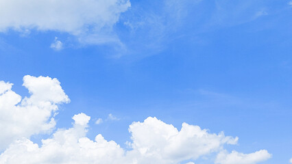 Bright white cumulus clouds floating in a clear blue summer sky. Blue sky with clouds. Soft white clouds float in the clear blue sky. Clear blue sky, bright spring, wallpaper landscape.