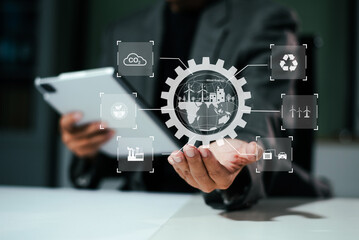 Man using futuristic interface with smart tech and mobile to manage ESG, clean energy, and sustainability data.