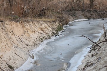 ice and snow on sandy beach in winter, closeup of photo