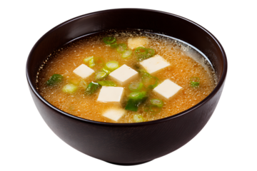 On transparent background a closeup shot of a steaming bowl of japanese miso soup filled with cubes of tofu and
