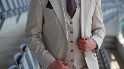 Close-up of a groom adjusting his beige suit and vest, preparing for a wedding ceremony. A stylish and elegant moment captured before the special event. - Powered by Adobe