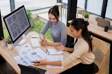 Two business women meeting with analytics in office as web developer in internship, workshop and company. Team, collaboration and digital agency for metrics, growth or career in brand design
