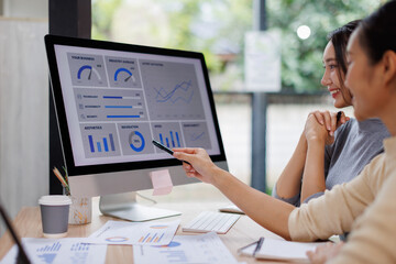 Two business women meeting with analytics in office as web developer in internship, workshop and company. Team, collaboration and digital agency for metrics, growth or career in brand design
