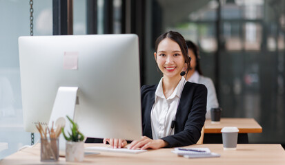 Young asian woman using a headset and computer in a modern office, Customer Service Representative, Service, Call Center, Using Phone, Office
