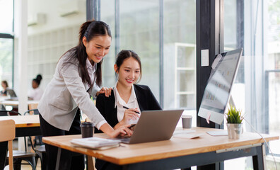Business asian women Reviewing Documents, Two business meticulously reviewing a stack of documents, highlighting the details and precision in work.	
