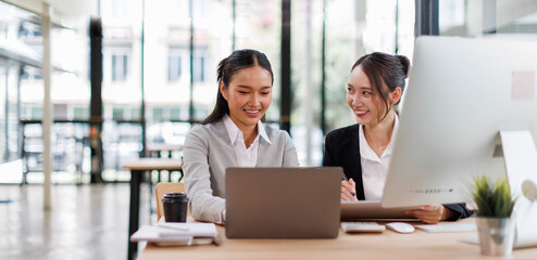 Group of confident business people point to graphs and charts to analyze market data, balance sheet, account, net profit to plan new sales strategies to increase production capacity.	