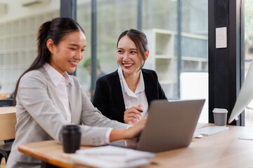 Group of confident business people point to graphs and charts to analyze market data, balance sheet, account, net profit to plan new sales strategies to increase production capacity.	