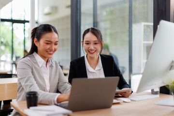 Group of confident business people point to graphs and charts to analyze market data, balance sheet, account, net profit to plan new sales strategies to increase production capacity.	