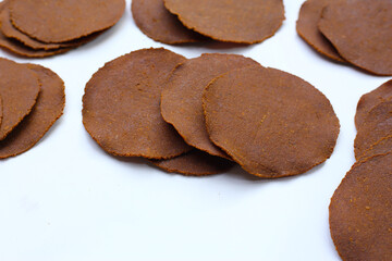 Fermented soybean discs, known as “Thua Nao,” a traditional Thai seasoning used to enhance...