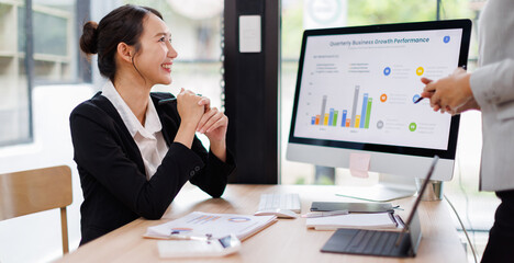 Two busy professional business asian working in office with computer. two female executive manager talking colleague having conversation showing software online solution on laptop.
