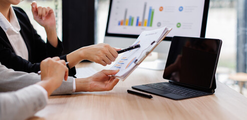 Business Asian meeting, data analytics or women with graph presentation in office for tablet, idea or laptop collaboration. Chart, analysis accounting team brainstorming economy, inflation or solution