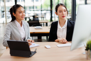 Business people group meeting in the office . Profession asian business women office workers working in team conference with project planning document on meeting table .
