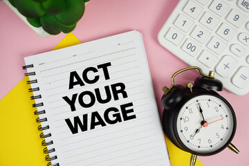 Act Your Wage text written on notepad with calculator and alarm clock on pink background