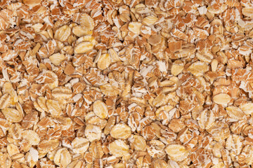 Macro shot of oat flakes showing their natural texture and color, great for backgrounds or nutrition-related concepts.
