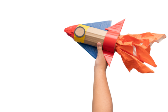 Hand Holding DIY Cardboard Rocket with Flames Isolated on White Background for Creativity Concept
