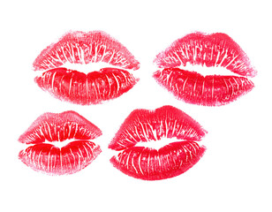 Four red lipstick kiss marks with detailed texture and creases, arranged in a square pattern on a black surface.