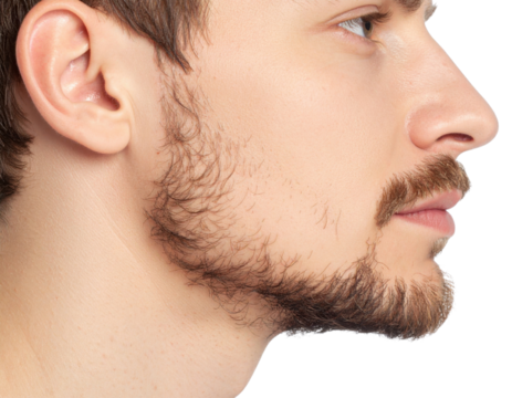 Close-up profile of a young man with a light beard and mustache against a black background.