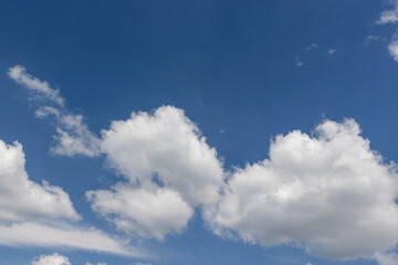 blue sky with lush white clouds in sunny bright weather, blue sky with cumulus clouds illuminated by sunlight
