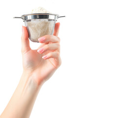Hand holding a tea strainer with loose leaf tea