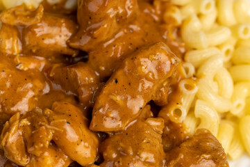 boiled pasta and pork stew with sauce, homemade cooked meat dinner with pasta