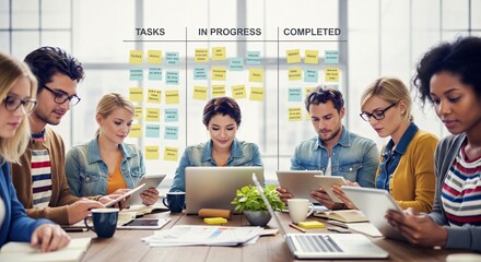 A collaborative team working together at the office on their tasks. They are using various tools and strategies to manage and complete projects