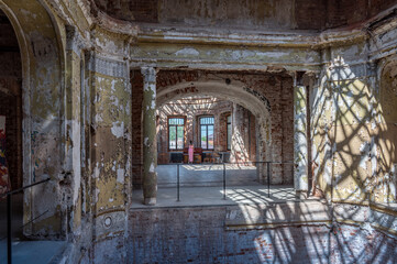 Corridor of an ancient abandoned castle. Interior illuminated by the sun.