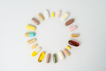 Clock made of pills capsules, pills form a circle, omega, vitamins, Cod liver oil, supplements