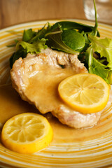 Lemon pork chop with fresh salad on ceramic plate