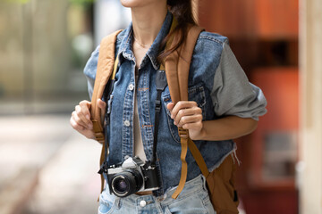 Adventurous Young Woman with Backpack and Camera