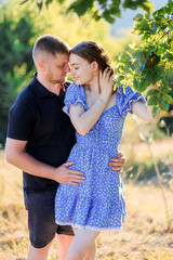 Fototapeta premium Couple enjoying a romantic moment in nature under warm sunlight