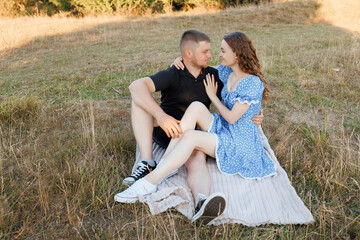 Couple enjoying a quiet moment together on a sunny day in a grassy field