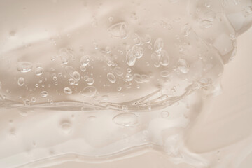 Glossy beige liquid gel makeup swatches in close-up, emphasizing the smooth, wet-look texture.