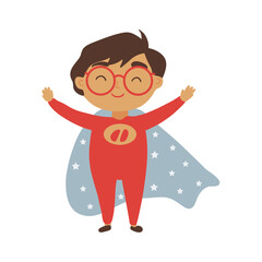 A cheerful boy with glasses dressed as a cartoon superhero in a red suit and cape dotted with stars, ready for fun and adventure.