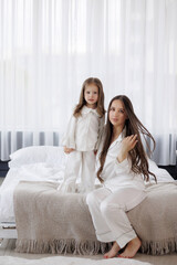 Mother and daughter in matching pajamas enjoying time together at home