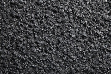 Fototapeta premium Dark asphalt close-up texture for urban exploration, road construction projects, or automotive enthusiasts seeking detailed pavement imagery in diverse environments