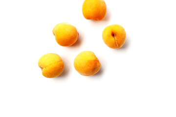 Fresh ripe apricots on a white background.