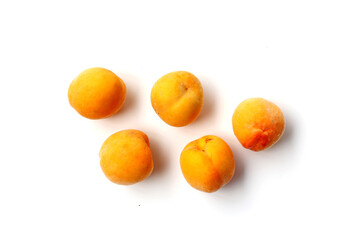 Fresh ripe apricots on a white background.